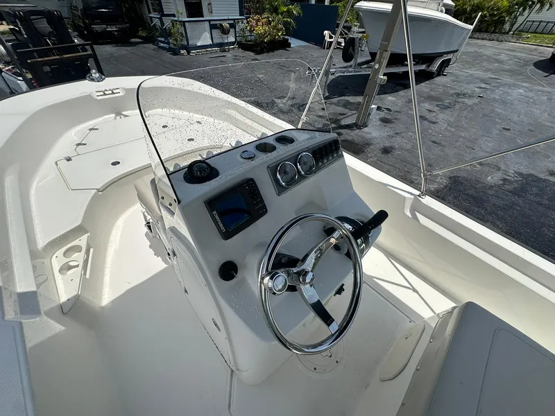 Slide: The Image of 2022 Boston Whaler 170 Montauk boat interior with steering wheel and control panel. - 17