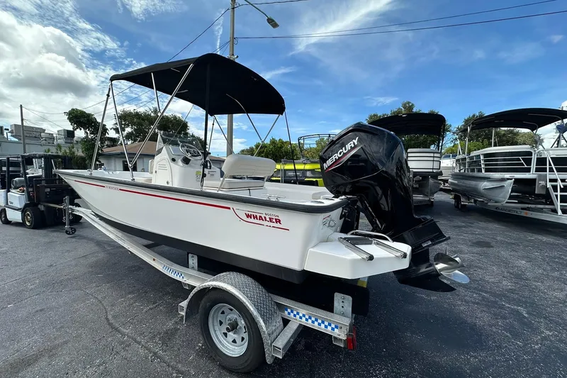 Slide: The Image of 2022 Boston Whaler 170 Montauk boat on trailer with Mercury outboard motor. - 2