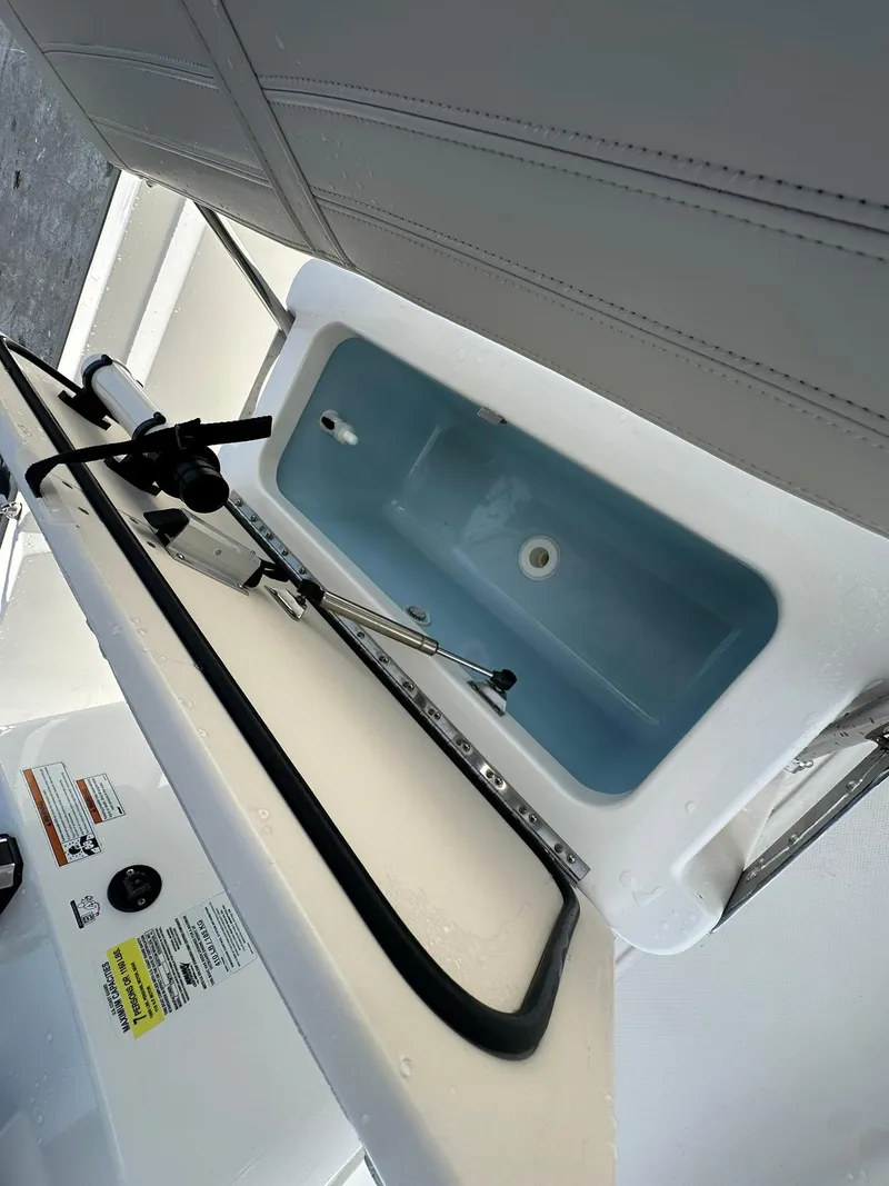 Slide: The Image of Livewell compartment on a 2022 Boston Whaler 170 Montauk boat, featuring a clean interior. - 21