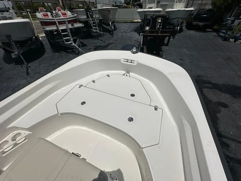 Slide: The Image of 2022 Boston Whaler 170 Montauk boat deck, showcasing storage compartment and seating area. - 22