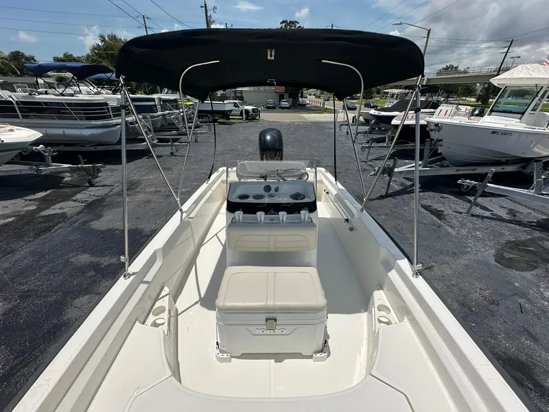 Slide: The Image of 2022 Boston Whaler 170 Montauk boat with canopy, parked in a marina. - 23