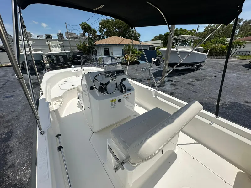 Slide: The Image of 2022 Boston Whaler 170 Montauk boat interior with steering console and seating. - 8