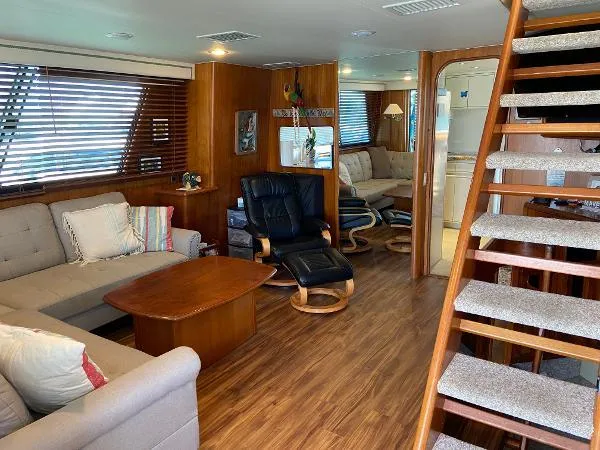 Slide: The Image of Luxurious 1990 Viking Extended Aft Deck Motor Yacht interior with cozy seating and wooden accents. - 5