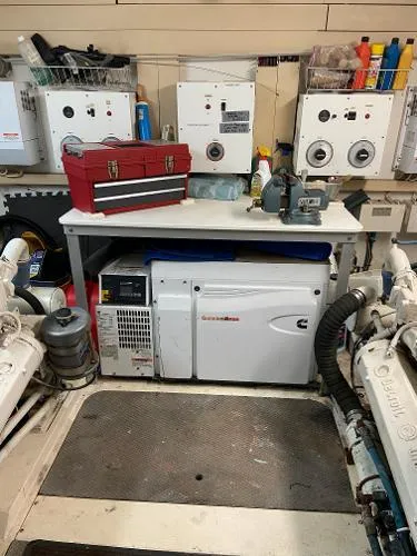 Slide: The Image of Engine room of 1990 Viking Extended Aft Deck Motor Yacht with tools and equipment. - 21