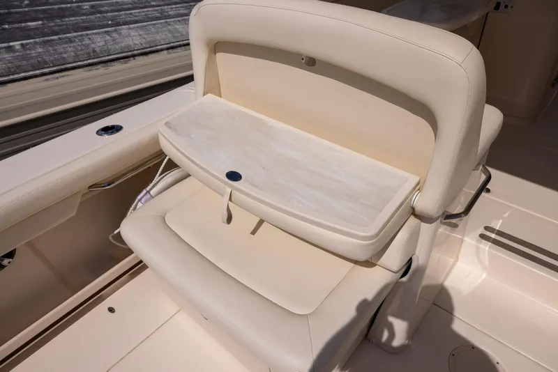 Slide: The Image of 2018 Grady-White Freedom 335 boat seat with foldable table, beige interior. - 12