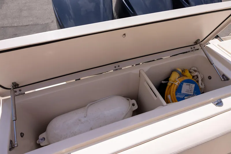 Slide: The Image of Storage compartment on a 2018 Grady-White Freedom 335 boat with safety equipment. - 13