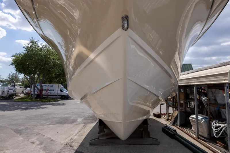 Slide: The Image of 2018 Grady-White Freedom 335 boat hull, parked outdoors under a clear sky. - 2