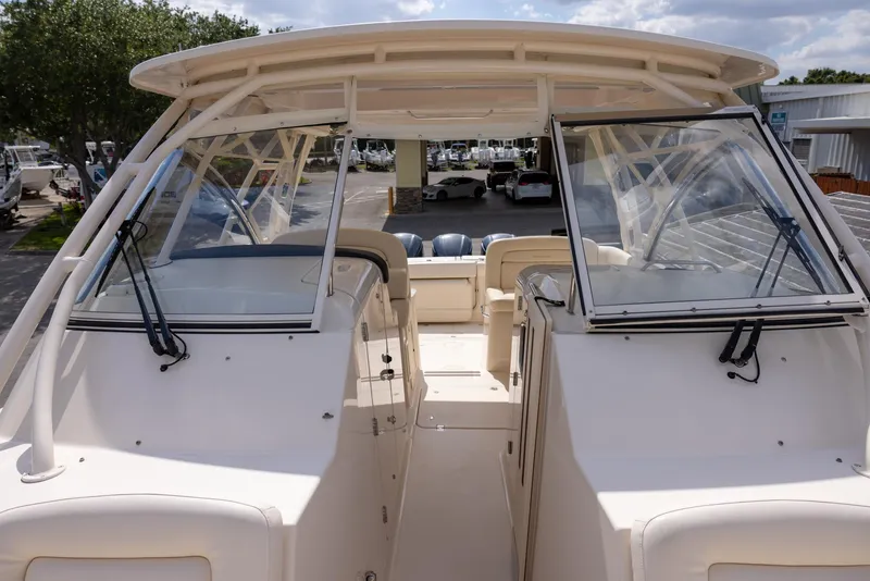 Slide: The Image of 2018 Grady-White Freedom 335 boat interior with open windshield and seating area. - 22
