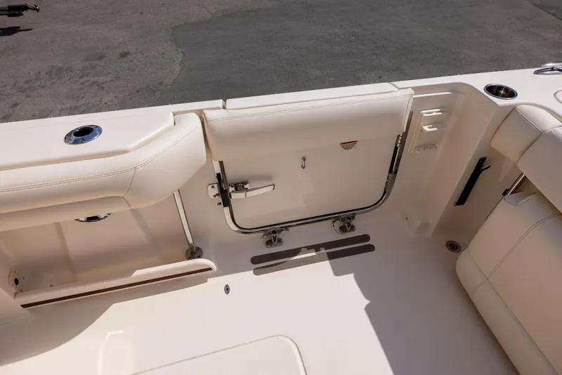 Slide: The Image of 2018 Grady-White Freedom 335 boat interior, featuring seating and storage area. - 8