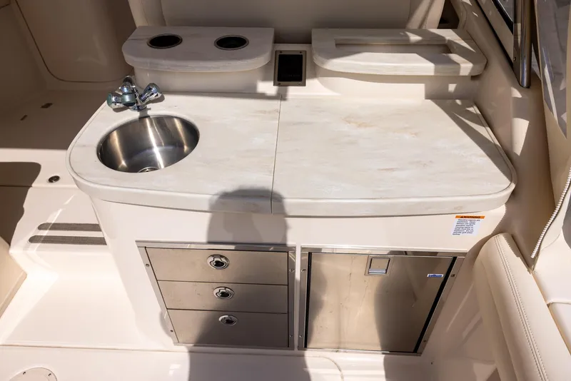 Slide: The Image of 2018 Grady-White Freedom 335 boat kitchenette with sink, storage drawers, and countertop. - 9