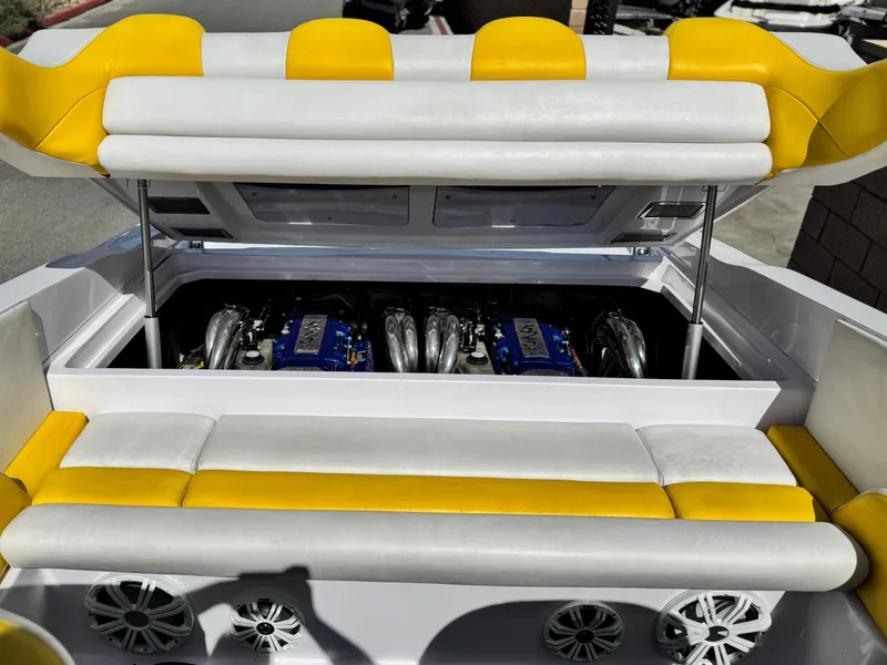Slide: The Image of 2004 Donzi 38 ZX boat engine compartment with yellow and white seating. - 12