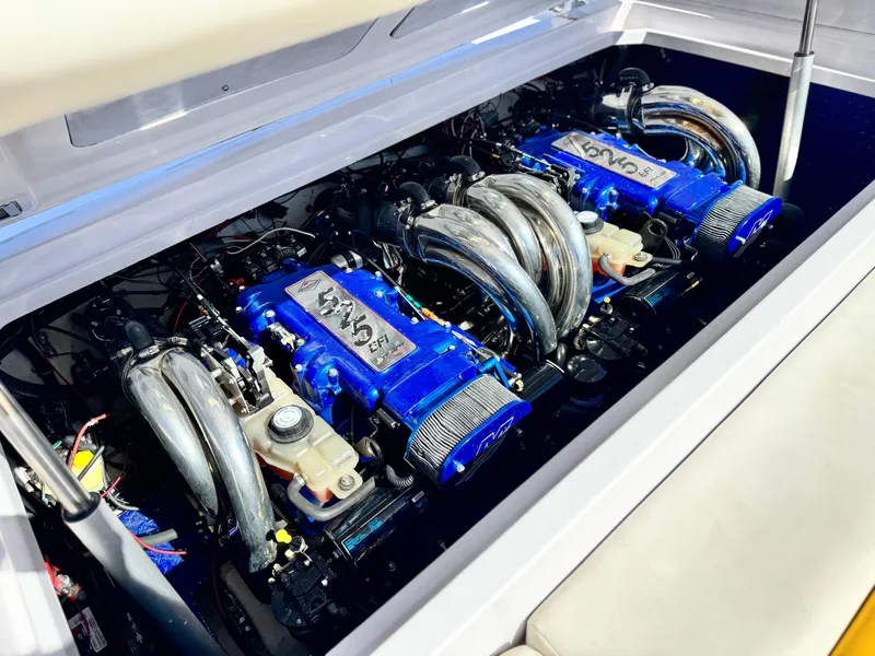 Slide: The Image of 2004 Donzi 38 ZX boat engine compartment with dual blue engines. - 14
