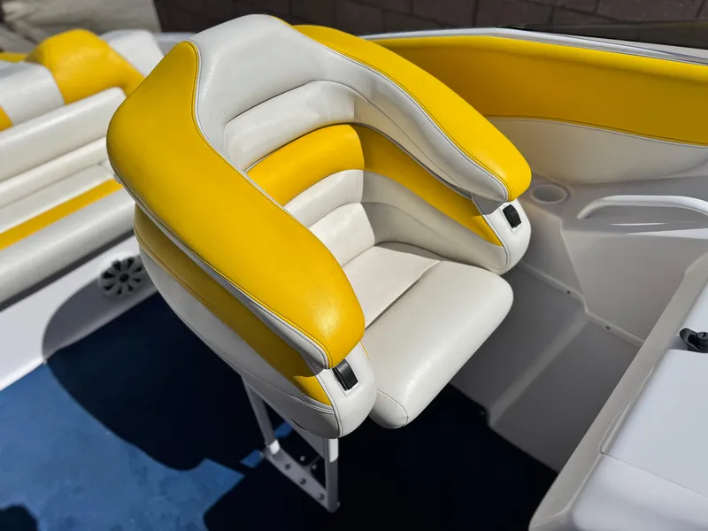 Slide: The Image of 2004 Donzi 38 ZX boat seat with yellow and white upholstery, showcasing sleek design. - 20