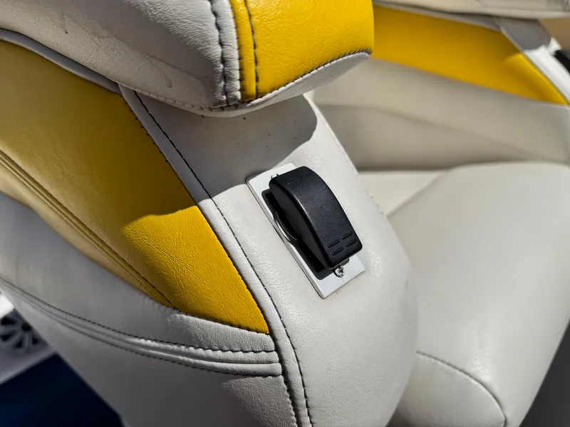 Slide: The Image of 2004 Donzi 38 ZX boat seat with yellow and white upholstery and a black switch. - 21