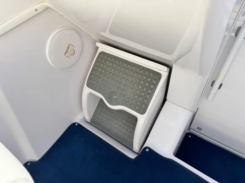 Slide: The Image of 2004 Donzi 38 ZX boat interior step with non-slip surface and blue carpet. - 22