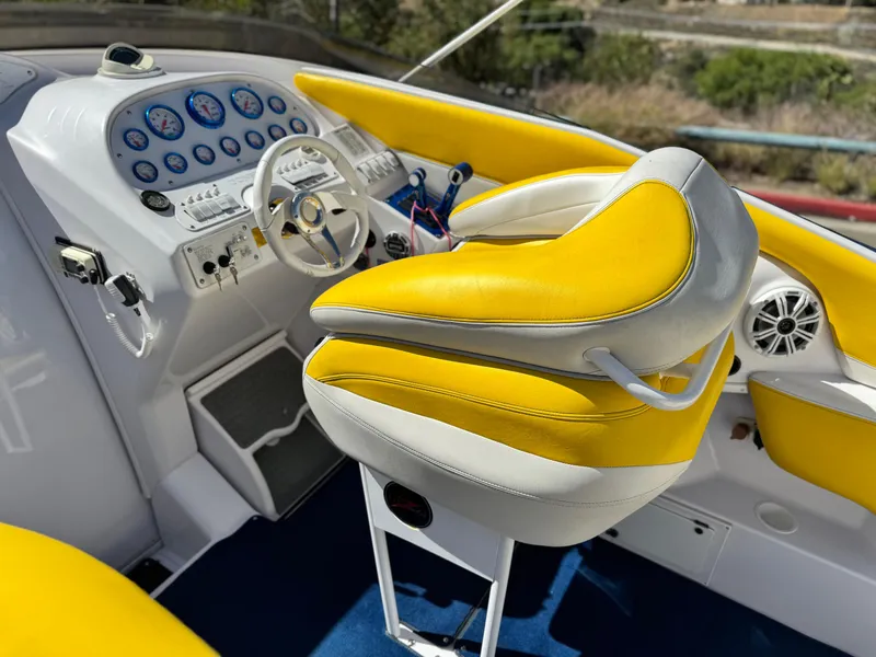 Slide: The Image of 2004 Donzi 38 ZX cockpit with yellow and white seating, detailed dashboard, and steering wheel. - 23