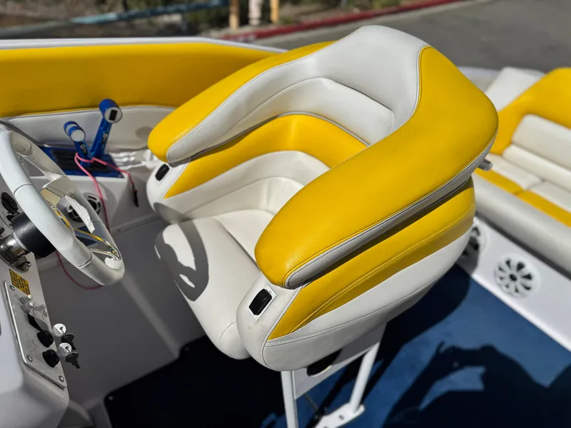 Slide: The Image of 2004 Donzi 38 ZX boat interior with yellow and white seating and steering wheel. - 29