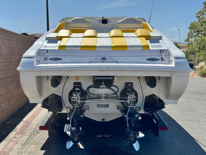 Slide: The Image of 2004 Donzi 38 ZX boat with yellow seating, rear view showing dual propellers. - 4