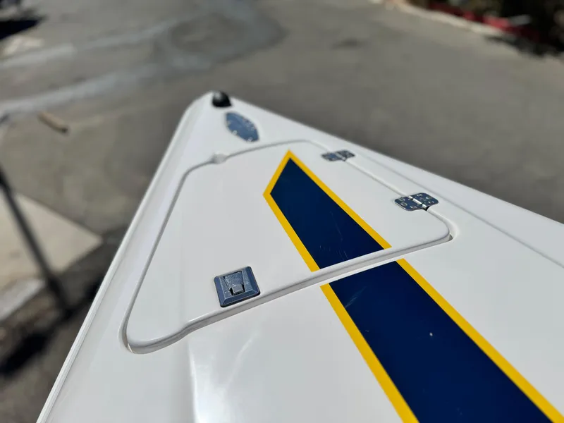 Slide: The Image of Close-up of 2004 Donzi 38 ZX boat's sleek design with blue and yellow accents. - 42