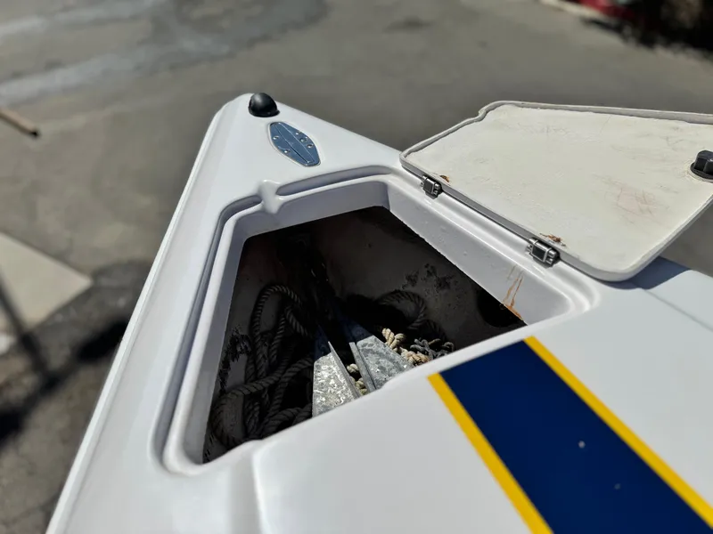 Slide: The Image of Open storage compartment on 2004 Donzi 38 ZX boat, featuring ropes and anchor. - 43