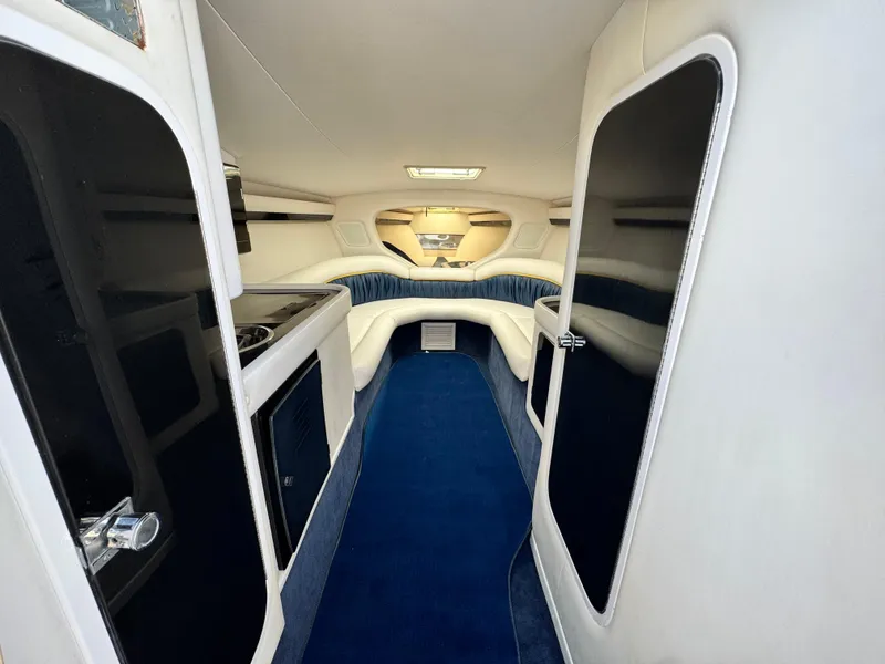 Slide: The Image of 2004 Donzi 38 ZX cabin interior with blue carpet and modern amenities. - 45