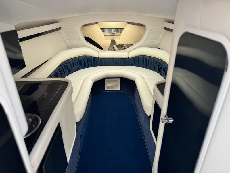 Slide: The Image of 2004 Donzi 38 ZX cabin interior with blue and white seating, modern design. - 46