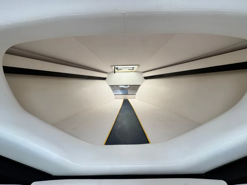 Slide: The Image of Interior cabin of a 2004 Donzi 38 ZX boat, featuring sleek white upholstery. - 48