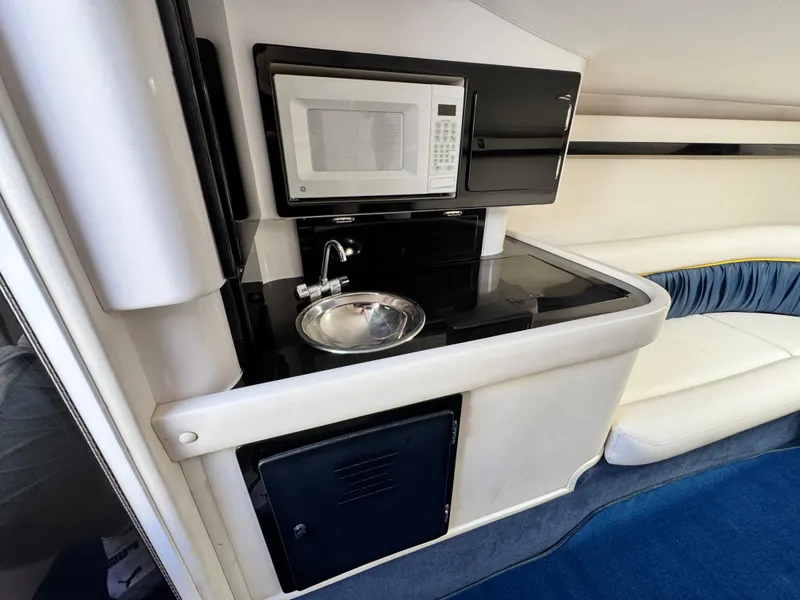 Slide: The Image of 2004 Donzi 38 ZX interior with kitchenette, featuring a microwave and sink. - 51