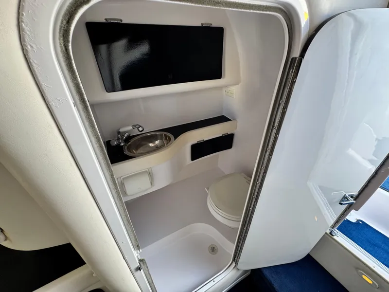 Slide: The Image of 2004 Donzi 38 ZX boat bathroom with sink, toilet, and shower. - 52