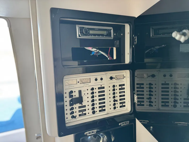 Slide: The Image of Control panel of a 2004 Donzi 38 ZX boat, featuring switches and wiring. - 56