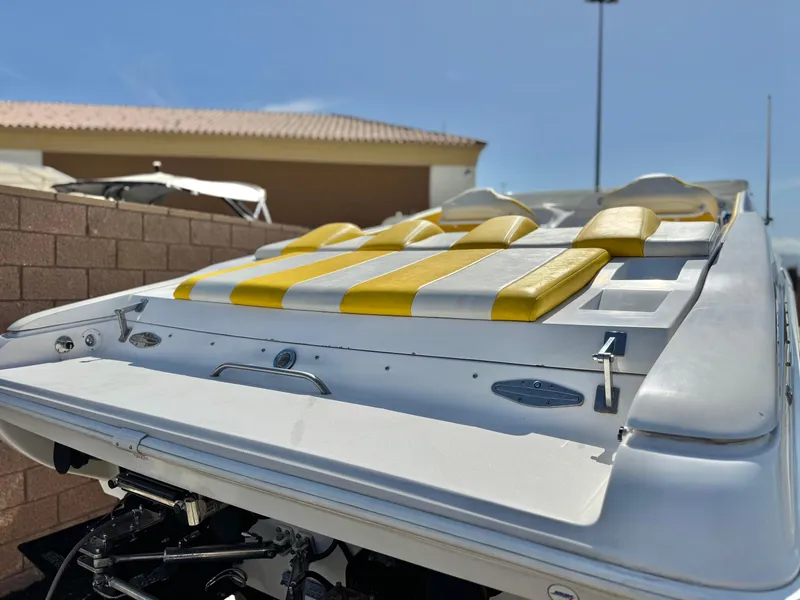 Slide: The Image of 2004 Donzi 38 ZX boat with yellow and white seating, docked outdoors. - 6