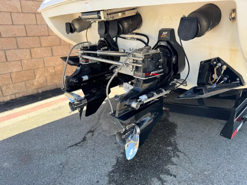 Slide: The Image of 2004 Donzi 38 ZX boat stern with dual propellers and outboard motors. - 8