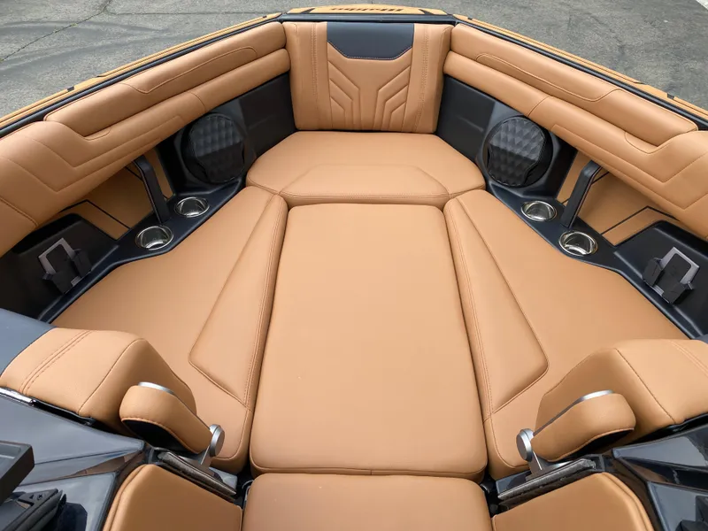 Slide: The Image of 2025 Malibu Wakesetter 25 LSV interior with tan leather seating and cup holders. - 10