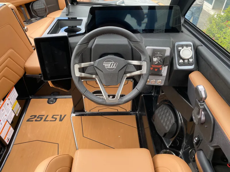 Slide: The Image of 2025 Malibu Wakesetter 25 LSV interior with modern steering and control panel. - 12