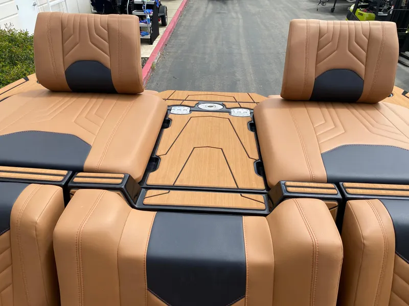 Slide: The Image of 2025 Malibu Wakesetter 25 LSV boat interior with tan and black seating. - 20