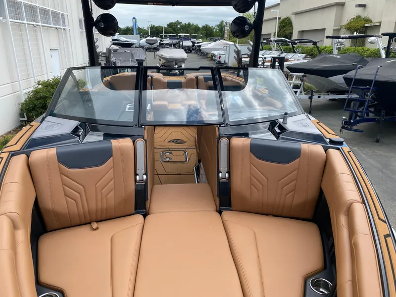 Slide: The Image of 2025 Malibu Wakesetter 25 LSV boat with tan leather seating and sleek design. - 21