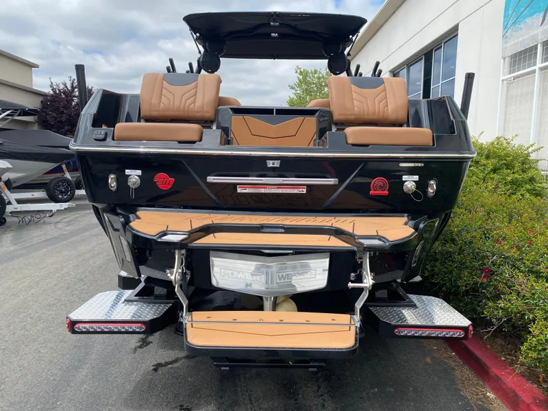 Slide: The Image of 2025 Malibu Wakesetter 25 LSV boat, rear view, showcasing seating and swim platform. - 6