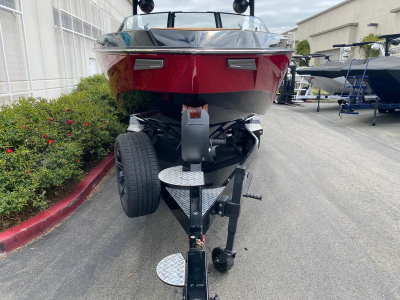 Slide: The Image of 2025 Malibu Wakesetter 25 LSV boat on trailer, front view, parked outdoors. - 8