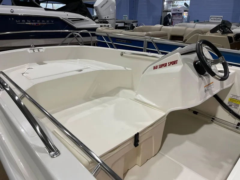 Slide: The Image of 2025 Boston Whaler 160 Super Sport interior with steering wheel and seating. - 3