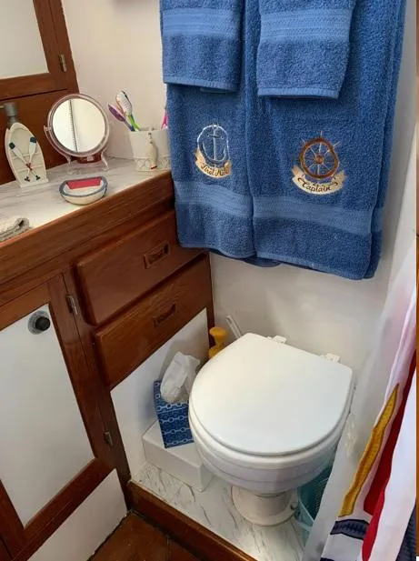Slide: The Image of Compact bathroom in 1985 Roughwater 36 boat with nautical-themed towels. - 14