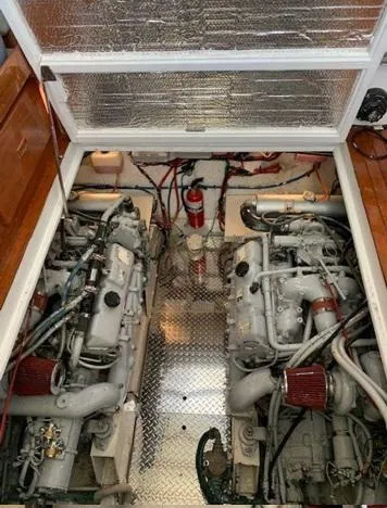 Slide: The Image of Engine room of a 1985 Roughwater 36 boat with dual engines and fire extinguisher. - 18