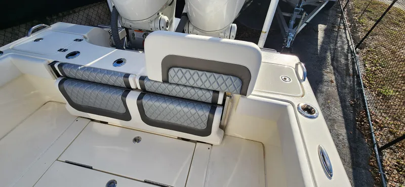 Slide: The Image of 2025 ShearWater 270 SS Open Carolina boat interior with cushioned seating and dual engines. - 10