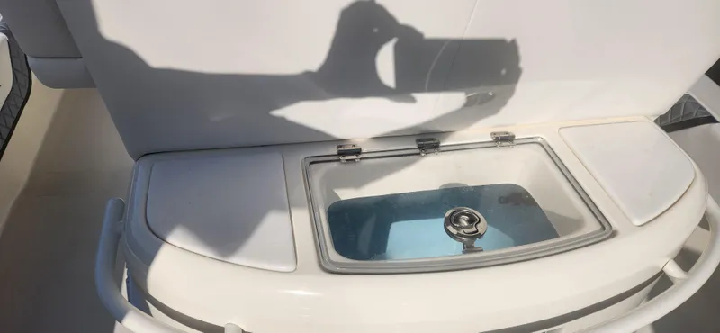 Slide: The Image of 2025 ShearWater 270 SS Open Carolina boat livewell with open lid and shadow. - 11