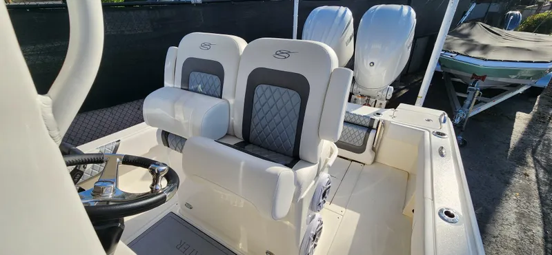 Slide: The Image of 2025 ShearWater 270 SS Open Carolina boat with dual engines and luxury seating. - 12