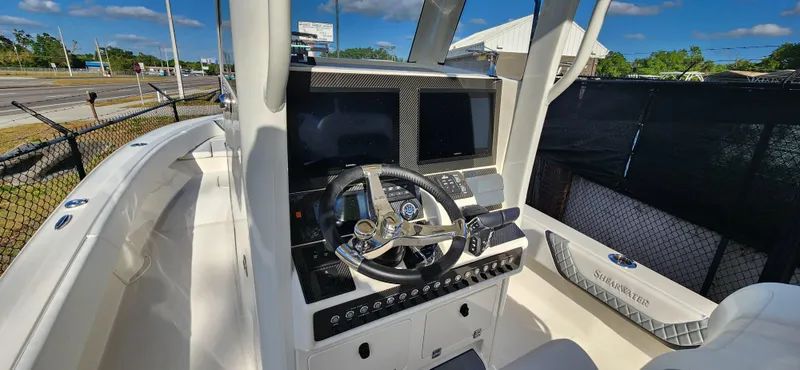Slide: The Image of 2025 ShearWater 270 SS Open Carolina boat cockpit with modern controls and steering wheel. - 13