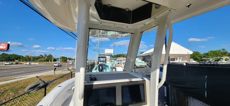 Slide: The Image of 2025 ShearWater 270 SS Open Carolina boat, docked with clear blue sky background. - 14