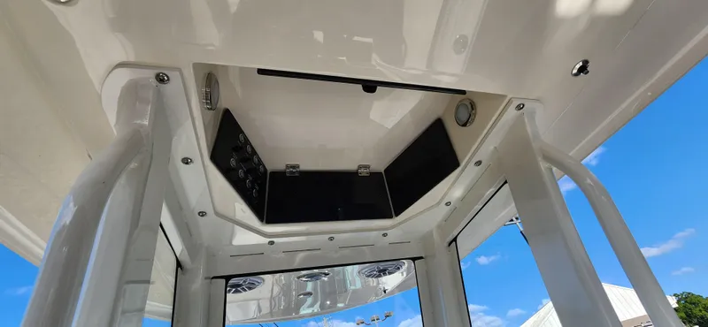 Slide: The Image of 2025 ShearWater 270 SS Open Carolina boat console under clear blue sky. - 15