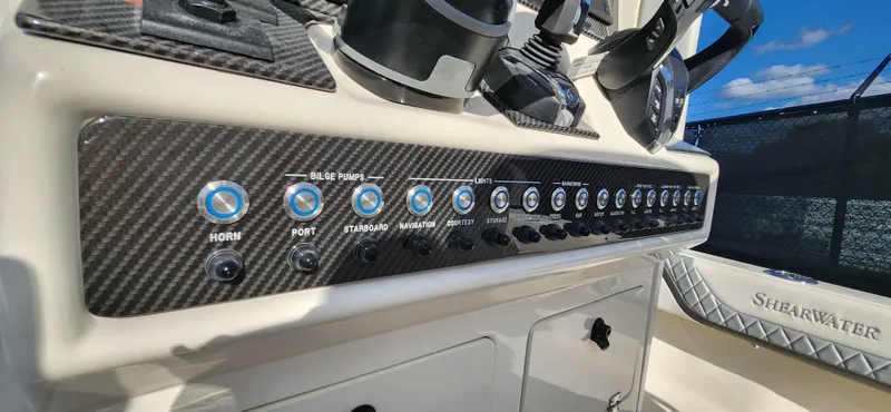 Slide: The Image of Control panel of 2025 ShearWater 270 SS Open Carolina boat with carbon fiber finish. - 16