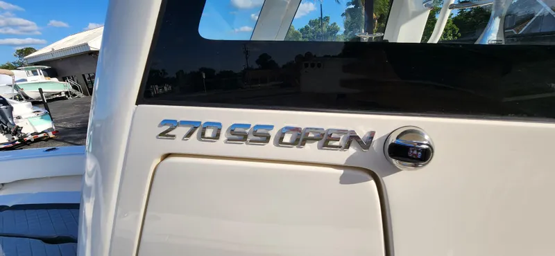 Slide: The Image of 2025 ShearWater 270 SS Open Carolina boat, close-up of model name on hull. - 20