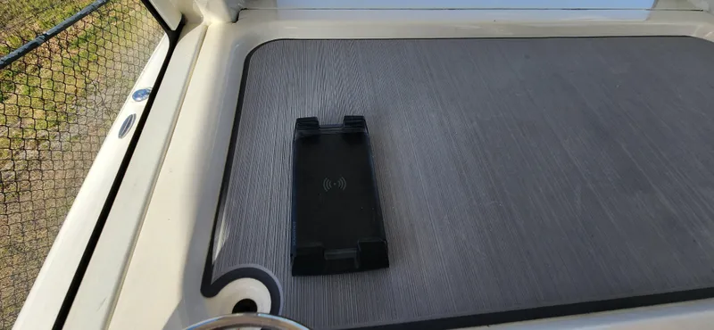 Slide: The Image of 2025 ShearWater 270 SS Open Carolina boat deck with wireless charging pad. - 21